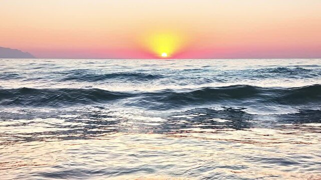 Close up view of the Ocean Waves Rolling Under a sunset.