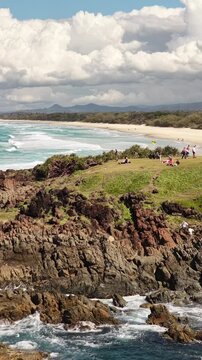 Aerial drone footage of surf rolling onto Hastings Point beach, Tweed Coast, NSW Australia - vertical video