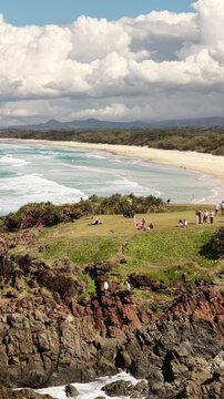 Hastings Point aerial view of the long beach and campground headland, NSW Australia - vertical video