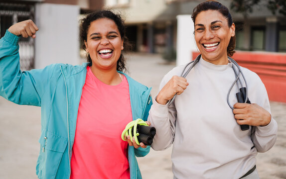 Fitness women athlete having fun after workout sessions outdoor - Happy people training outside - Empowering, healthy lifestyle and sport concept - Main focus on left female face