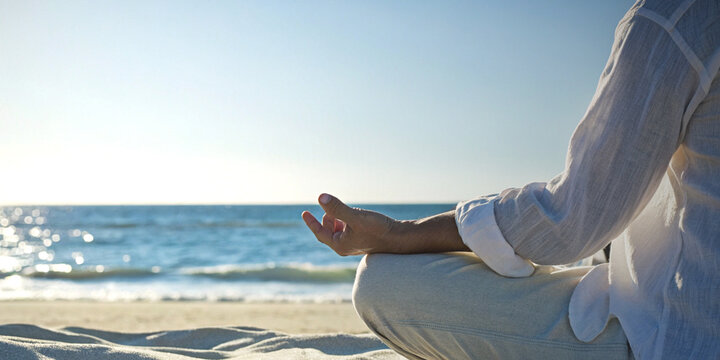 Being mindful and practicing calmness in mind to reduce stress with a woman meditating on the beach in the morning