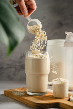 Adding vanilla protein powder to glass for muscle recovery beverage