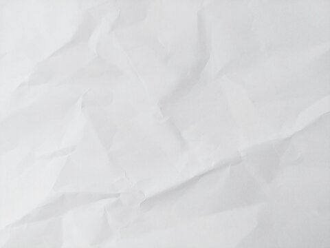 White empty crumpled wrinkled paper background texture. Clean blank paper sheet surface. Abstract white paper texture pattern background.