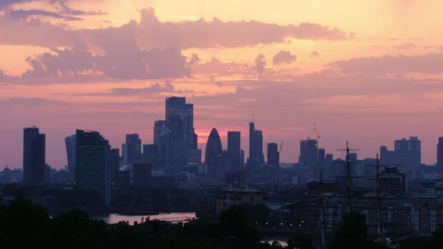 Wide angle panorama of London's skyline at sunset, featuring the BT Tower, St Paul's Cathedral, Gherkin, 22 Bishopsgate, The Shard and the Thames.