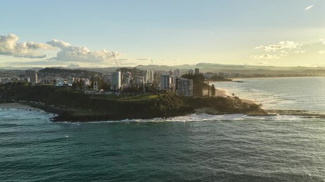 Sunset over Snapper Rocks with the Gold Coast skyline in the distance, aerial drone view, Queensland Australia
