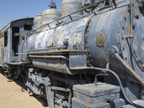 View of a vintage steam locomotive at Death Valley National Park, featuring weathered metal, rusted details, and mechanical components in Death Valley, California, United States.