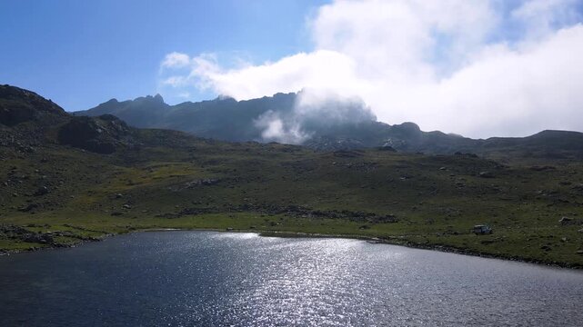 footage of foggy cloudy mountains and crater lake.