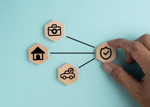 Car, health, real estate insurance concept - abstract signs on wooden cubes with a blue background. Insurance concept.
