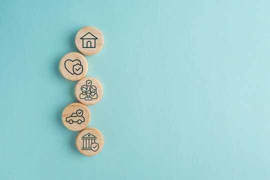 Insurance symbols on wooden blocks. Insurance and security concept. Health, life and valuable items insurance. Securing the family. Insurance concept.