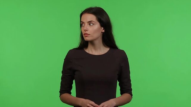Suspicious Young Woman Looking Sideways with Skeptical Expression on Green Screen Background for Professional Chroma Key Composition