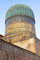 Ribbed turquoise dome of Bibi-Khanym Mosque in Samarkand featuring intricate geometric tilework and golden brickwork. Ideal for travel guides, cultural publications, and architectural references. © finepoints