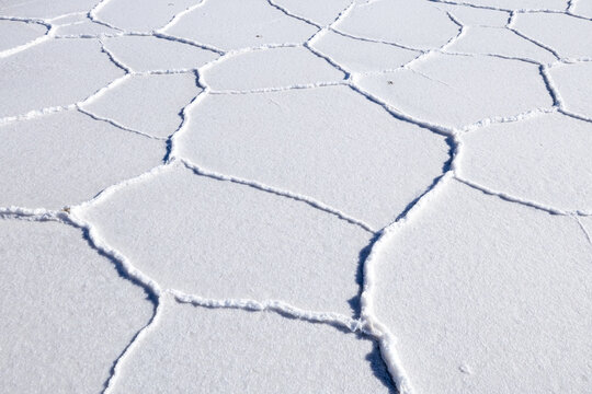 View of the hexagonal salt crust patterns of the Uyuni Salt Flat in Bolivia.