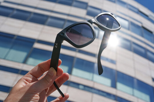 Dusseldorf, Germany - July 10 2026: Hand holding Ray-Ban Meta smart glasses outside in bright sunshine