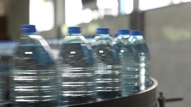 Plastic Water Bottles Moving Along Bottling Production Line