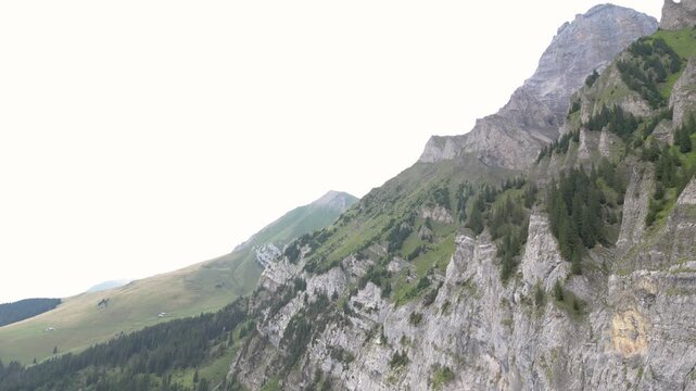 Cinematic aerial drone footage showcasing the spectacular alpine landscape, mountain peaks, green valleys and traditional village of Adelboden in the Bernese Oberland, Switzerland.
