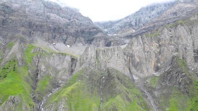 Cinematic aerial drone footage showcasing the spectacular alpine landscape, mountain peaks, green valleys and traditional village of Adelboden in the Bernese Oberland, Switzerland.