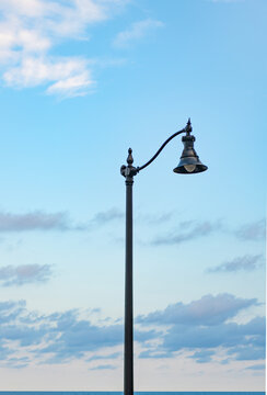 Urban architecture details. Street lamp lantern against blue sky. Elegant street lamp in urban style. Architectural details and lamp on empty street