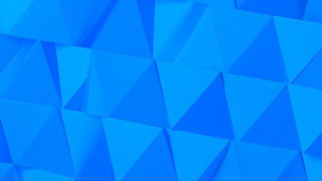 Blue polygonal panels shift across an abstract geometric digital surface. Technology presentations, website headers, and motion graphics projects.