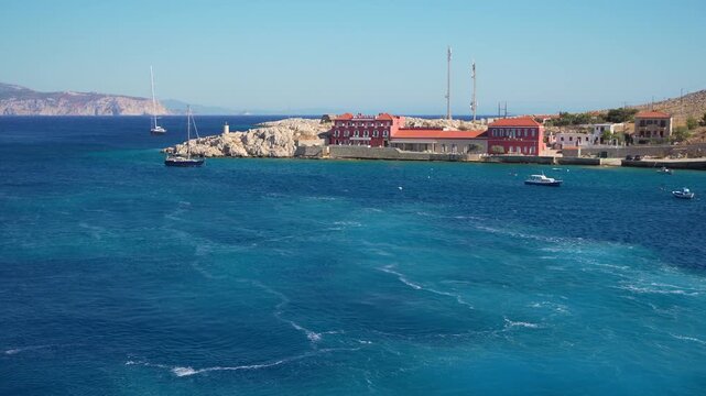 Beautiful coast with turquoise sea of Halki island, Greece. Traditional greek architecture on the sea shore. Travel and summer vacation concept. 
