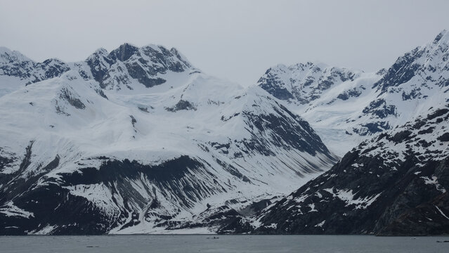 Breathtaking Alaska mountain glacier range view seen from outdoor deck of cruise ship liner sailing the Inside Passage transit with spectacular landscape wilderness scenery