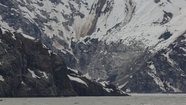 Breathtaking Alaska mountain glacier range view seen from outdoor deck of cruise ship liner sailing the Inside Passage transit with spectacular landscape wilderness scenery