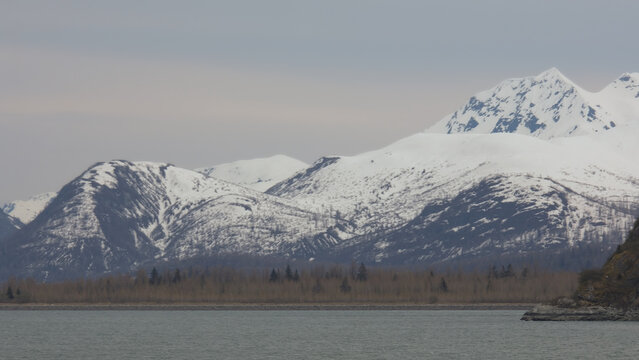 Breathtaking Alaska mountain glacier range view seen from outdoor deck of cruise ship liner sailing the Inside Passage transit with spectacular landscape wilderness scenery