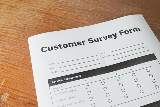 Close up of a blank customer survey form on a wooden desk. Concept of customer satisfaction, service quality assessment, business marketing research, and consumer feedback evaluation.