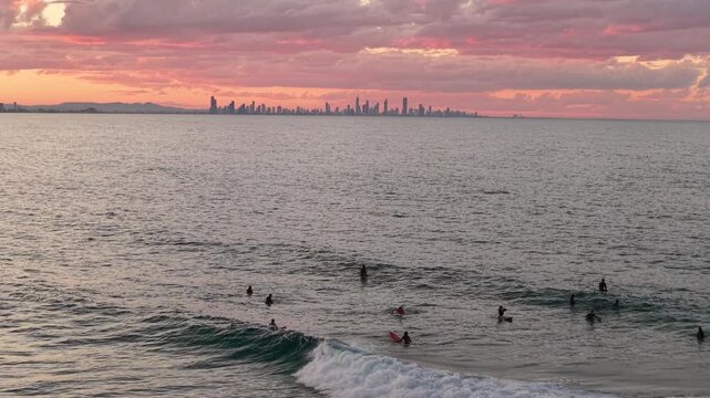 Surfers in the lineup at Snapper Rocks at sunset, aerial drone footage, Coolangatta, Gold Coast, Queensland Australia
