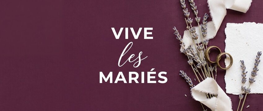 Wedding rings lavender flat lay elegant French marriage concept with text Vive les Maries on dark purple linen background for romantic bride groom invitation banner card layout composition copy space.