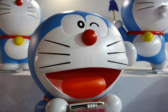 A close up of a cheerful Doraemon statue winking.