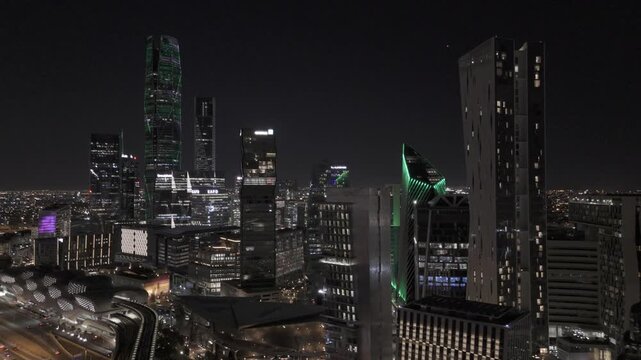 Aerial Pullback Establishing Shot of KAFD Skyline at Night in Riyadh
