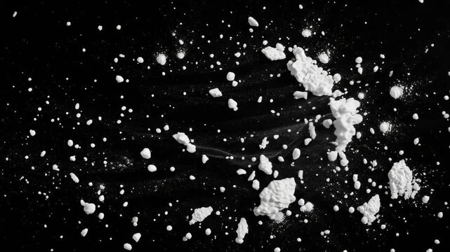White powder particles on black background, scattered flour or cocaine dust texture, messy granular debris for cinematic overlays