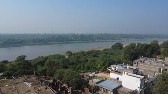 Drone Flying Over Tapi River Toward a Rural Village in Maharashtra, India