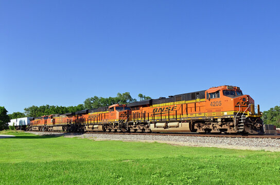 A trio of locomotives pace a westbound Burlington Northern Santa Fe stack train through northeastern Illinois.
