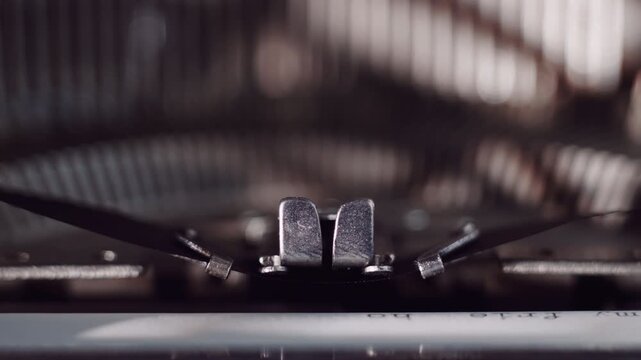 Close view of typewriter keys and ribbon showing the mechanics while sunlight comes through the window in a cozy workspace