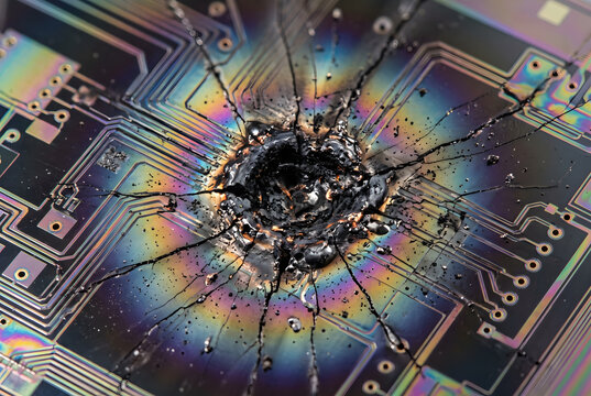 Close-up of Microscopic Laser Burn Mark on Silicon Wafer Indicating Hardware Exploit