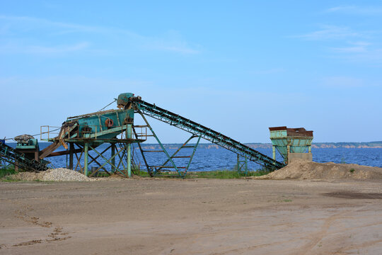 Industrial Conveyor Belt System on Beach Shoreline, soil alluvium