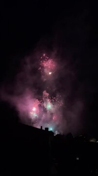 Spectacular fireworks exploding in the night sky over Olot, Spain