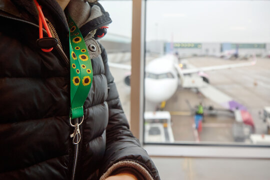Person wearing sunflower lanyard at airport, hidden disability