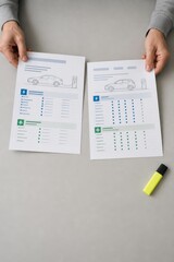 Obraz premium Used Electric Vehicle Battery Health Hands Comparing Fictional EV Maintenance Records