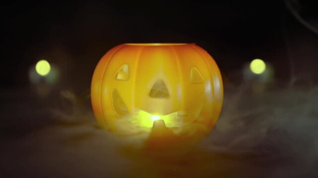 Thick fog or smoke creeps around the base of the pumpkin, creating a mysterious, dramatic, and eerie atmosphere.