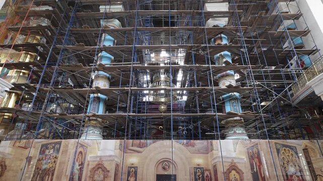 View of the interior of the Cathedral of the Intercession of the Mother of God under restoration with scaffolding and religious murals in Vladivostok, Primorsky Krai, Russia.