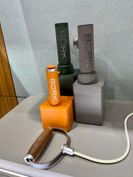  collection of modern fitness equipment on a sleek surface. The set Bork includes two rectangular weights in green and gray, one small orange weight