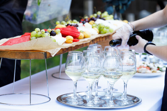 A banquet table set with appetizers and fruit, a buffet for an outdoor celebration, and on-site catering services