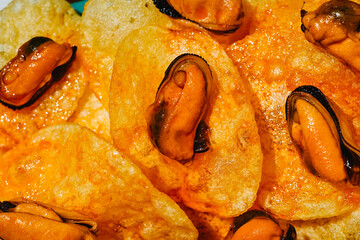 textured close-up of mussels on potato chips © nito