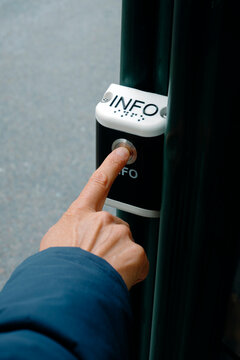 close-up of a man pressing an information button