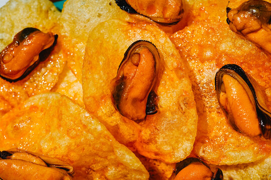 textured close-up of mussels on potato chips