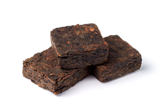 Black pu-erh Chinese tea. Pressed tiles of fermented black tea isolated on white background.