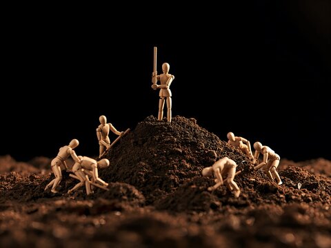Generative AI depicts miniature wooden figures mining and defending a mound