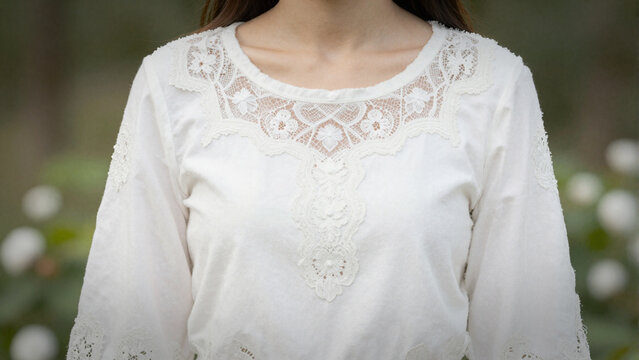 Elegant white lace embroidered blouse textile detail